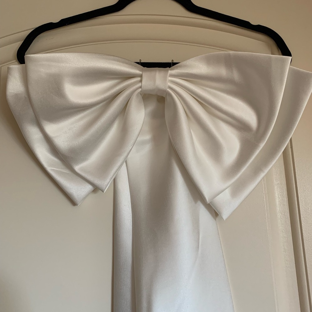 Large white satin like bow. Attach to dress for a bow back dress.